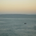 Robben Island in the background with the "Pirate Ship" passing in front on a sunset cruise