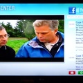 Social Center app showing Facebook feed alongside the TV display