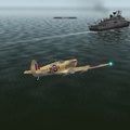 Spitfire flying past a Frigate