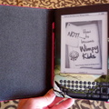 View of Kaylyn's new Kindle with the pink cover and DecalGirl skin