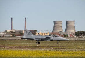 Gripen Fighter taxying in with Cooling Towers in background