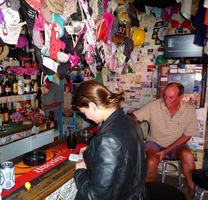 Chantel examining the geocache's logbook at Ronnie's Sex Shop